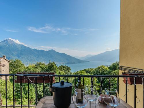 a table with wine glasses on a balcony with a view at Apartment Buongusto by Interhome in Bugiallo