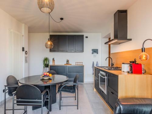 a kitchen with a table and chairs in a kitchen at Apartment Buongusto by Interhome in Bugiallo