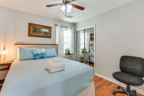 a bedroom with a bed and a chair at Bluffton Getaway with Fenced Yard 7 Mi to Beach! in Bluffton