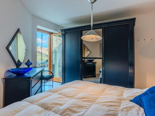 a bedroom with a bed and a desk and a window at Apartment Buongusto by Interhome in Bugiallo