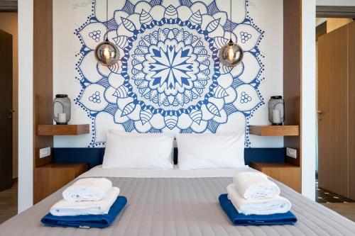 a bedroom with a bed with towels on it at BlueSkyline Owner's Listing, By Hellocrete in Chania Town