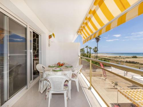 a table and chairs on a balcony with a view of the ocean at Apartment Bahia by Interhome in Cunit
