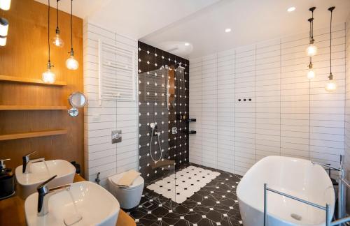 a bathroom with two sinks and a tub and a shower at BlueSkyline Owner's Listing, By Hellocrete in Chania Town