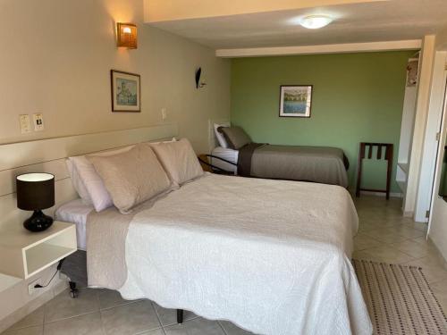 a bedroom with two beds in a room at Pousada Do Forte in Paraty