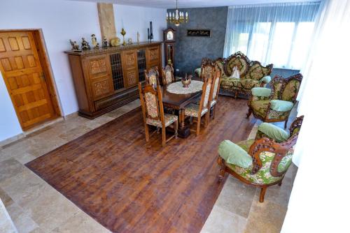 a living room with a table and chairs at Agropensiune Lupu 