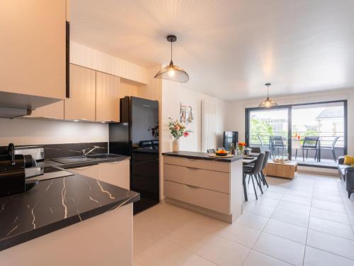 a kitchen with black countertops and a dining room at Apartment Chasse Marée by Interhome in Quiberon