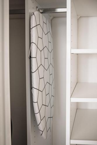 a white walk in closet with a surfboard at GottwaldHaus - Freiberg - Apartment - F in Freiberg