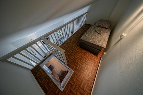 an overhead view of a staircase with a bench in a room at GottwaldHaus - Freiberg - Apartment - F in Freiberg
