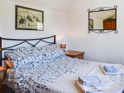 a bedroom with a bed with towels on it at Bray View Cottage in Davidstow