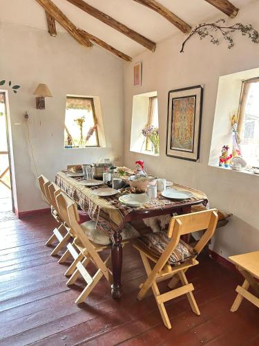 a dining room with a table and chairs at Sacred Valley Mystic Tribe - Community Life in Pisac