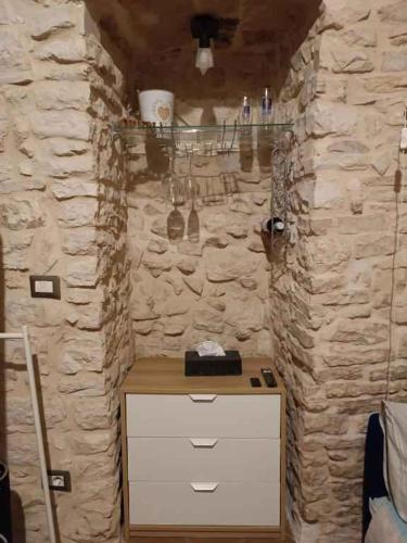 a bathroom with a counter and a stone wall at Studio in Giovinazzo - Apulien 54437 in Giovinazzo