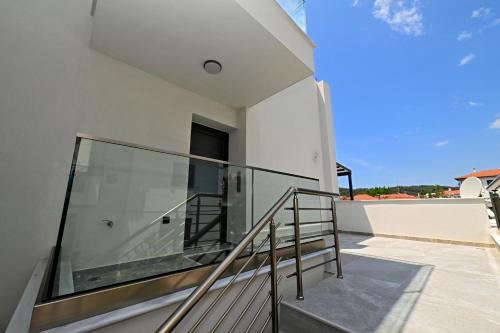 a glass railing on the balcony of a house at Agios Nikolaos Villas in Ayios Nikolaos Sithonia