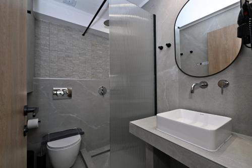 a bathroom with a sink and a mirror at Agios Nikolaos Villas in Ayios Nikolaos Sithonia