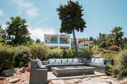 a garden with a couch and a fire pit at BlueSkyline Owner's Listing, By Hellocrete in Chania Town