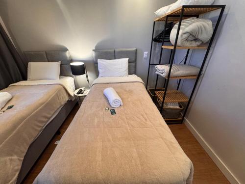 two beds sitting next to each other in a room at Nobile Congonhas in Sao Paulo