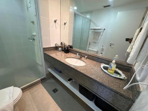 a bathroom with a sink and a shower at Nobile Congonhas in Sao Paulo