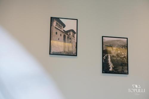 three framed photographs hanging on a white wall at Villa Topulli View in Gjirokastër
