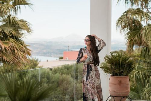 a woman in a dress leaning against a wall at BlueSkyline Owner's Listing, By Hellocrete in Chania Town