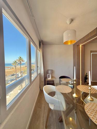 a living room with a view of the beach at The View Costa Caparica in Costa da Caparica