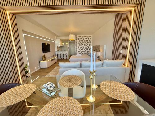 a living room with a bed and a table with chairs at The View Costa Caparica in Costa da Caparica
