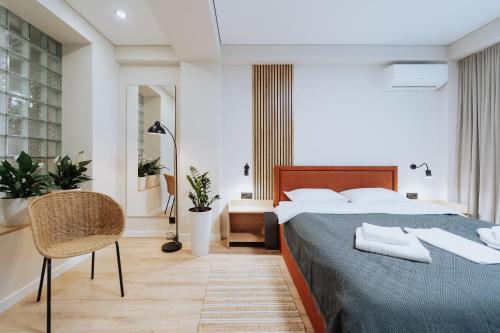 a bedroom with a large bed and a chair at NEW 2BR Near Rîșcani Park in Chişinău
