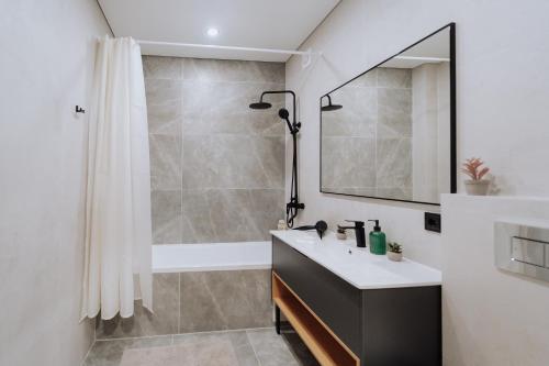 a bathroom with a sink and a shower at NEW 2BR Near Rîșcani Park in Chişinău