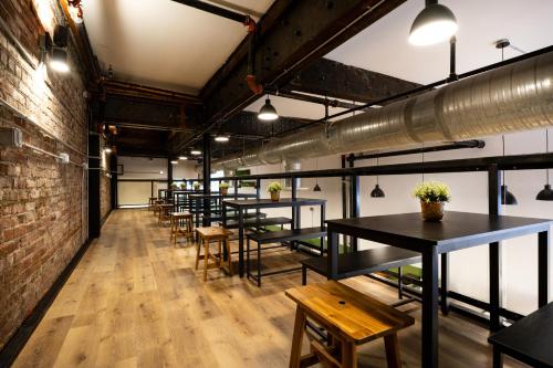 a row of tables and benches in a room at Samesun Vancouver in Vancouver
