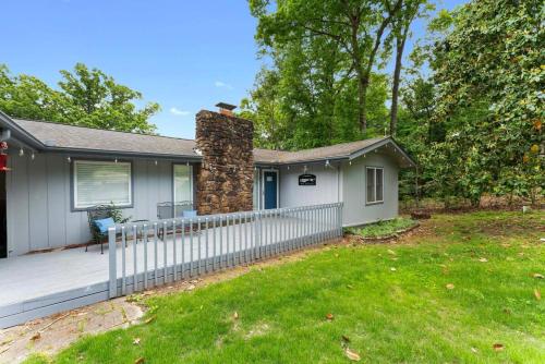 a house with a fence in front of a yard at 5 BR lakefront home with swim dock bunk room High Speed WiFi in Shell Knob
