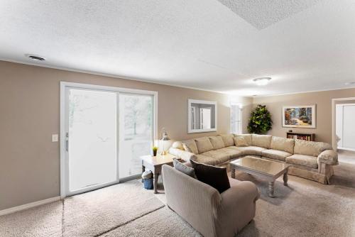 a living room with a couch and a table at 5 BR lakefront home with swim dock bunk room High Speed WiFi in Shell Knob