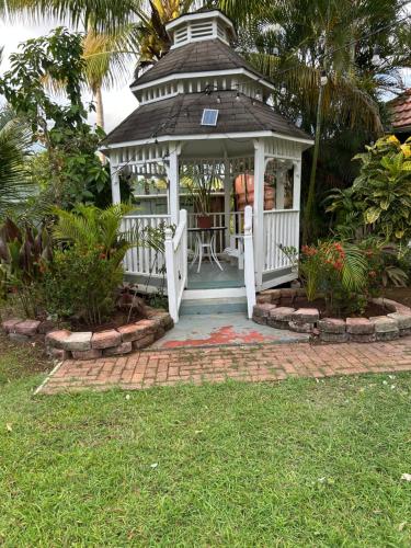 a white gazebo with a table in it at Rayon Hotel in Negril