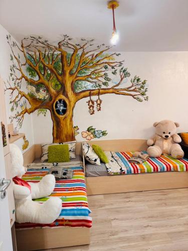 a childs bedroom with a tree mural on the wall at Elisea apartment in Ruse