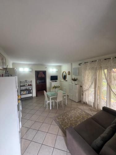 a living room with a couch and a table at Yellow House B&B in Ciampino