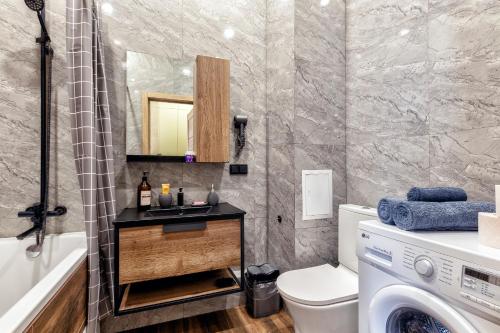 a bathroom with a sink and a washing machine at 1-комнатная квартира Кумисбекова 4, ЖК Altyn Tau in Astana