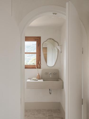 a bathroom with a sink and a mirror at Om Living Pelion in Agios Dimitrios