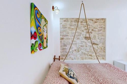 a room with a painting hanging on the wall at Antico Borgo dei Templi in Agrigento