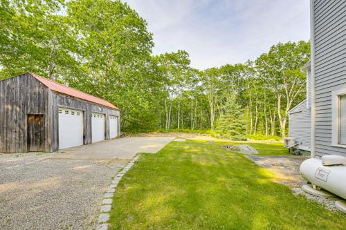 an old barn and a garage next to a house at Spacious Kennebunkport Home with View, 2 Mi to Beach in Kennebunkport