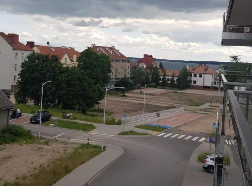 a view of a street in a city with buildings at Nowoczesny apartament z dużym tarasem i widokiem na jezioro in Giżycko