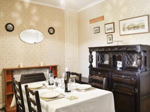 a dining room with a table with a white table cloth at Number 4 in Llandeilo