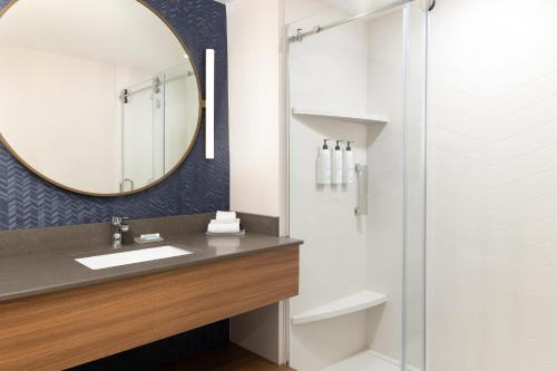 a bathroom with a sink and a mirror at Fairfield by Marriott Inn & Suites Spokane Airport in Spokane