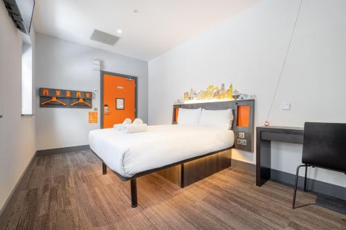a bedroom with a large bed in a room at easyHotel Belfast in Belfast