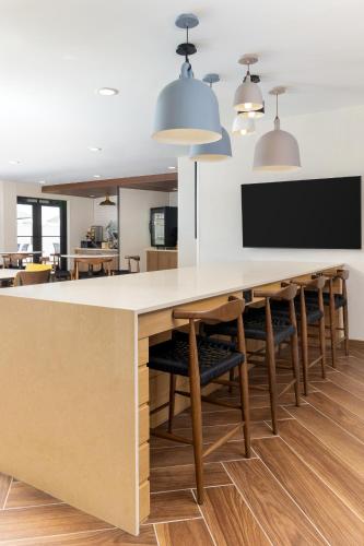 a large kitchen with a long table and chairs at Fairfield by Marriott Inn & Suites Spokane Airport in Spokane