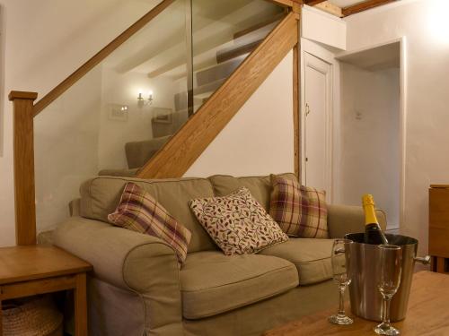 a living room with a couch and a staircase at Uk32422 - 4 Banc Llugwy in Betws-y-coed