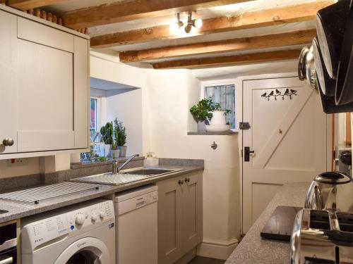 a kitchen with a sink and a washing machine at Uk32422 - 4 Banc Llugwy in Betws-y-coed
