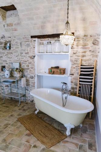 a bath tub in a room with a table at Villa Adriatica - Character Home, Costa dei Trabocchi in Villalfonsina