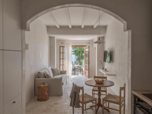 a living room with a table and a couch at Om Living Pelion in Agios Dimitrios