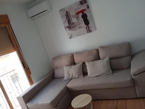 a living room with a couch and a table at Los tres balcones in Caravaca de la Cruz