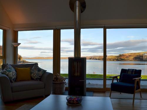 a living room with a view of the water at Rowan House in Fiskavaig
