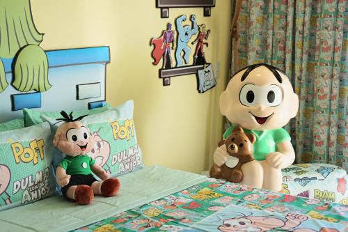 a bedroom with stuffed animals sitting on a bed at Bourbon Resort Atibaia in Atibaia