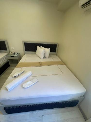 a bed in a small room with a white bedvisor at Ambiance Downtown Cairo Hotel in Cairo