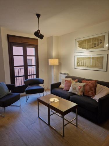 a living room with a couch and a table at Casa Albañil in La Puebla de Castro